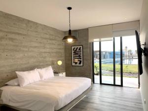 A bed or beds in a room at 3BR Concrete Cove in Paracas Beach