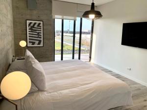 A bed or beds in a room at 3BR Concrete Cove in Paracas Beach