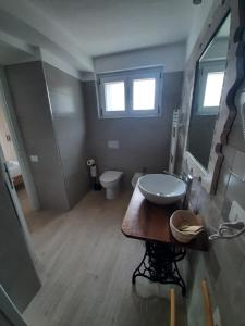 a bathroom with a sink and a toilet at B&B La casa dei nonni Assergi in Assergi