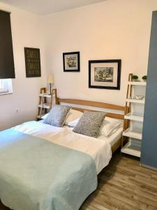 a bedroom with two beds and a book shelf at Apartments Mare in Punat