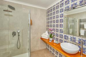 a bathroom with a sink and a shower at Villa Giardini Luxury Room in Capri