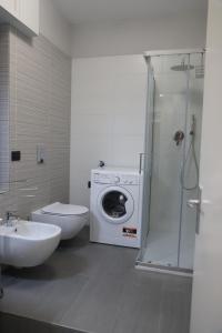 a bathroom with a washing machine and a toilet at CASA DIDYMA in San Giovanni Gemini +99 photos