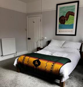 a bedroom with a bed with a colorful blanket on it at Shaftesbury Centre in Shaftesbury