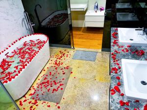 a cake with red flowers on the floor in a bathroom at Saba Suites at Platinum KLCC Bukit Bintang Kuala Lumpur in Kuala Lumpur