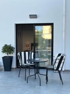 a table and chairs sitting on a patio at Zoi Ayia Napa in Ayia Napa