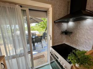 a kitchen with a glass door leading to a patio at Villa MAXIMILIYAN in Albena