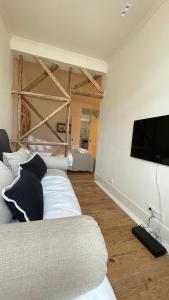 ein Wohnzimmer mit einem Sofa und einem Flachbild-TV in der Unterkunft Eco Luxury apartment LISBOA-Campo de Ourique in Lissabon
