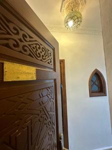 a room with a door and a chandelier at Kasba blanca in Tangier