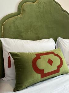 a pillow on a bed with a green headboard at Kasba blanca in Tangier