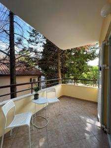 a balcony with a table and chairs on it at Lamada Family Two Bedroom Apartment in Budva