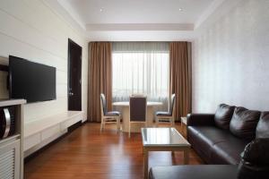 a living room with a couch and a table at Four Points by Sheraton Medan in Medan