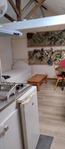 een keuken met een fornuis, een bank en een tafel bij La Maison du Saule in Pompignac