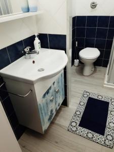 a bathroom with a sink and a toilet at Casa vacanza Viola in Trapani +35 photos
