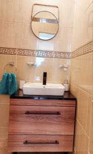 a bathroom with a sink and a mirror at Apartmani Radovic in Bijela