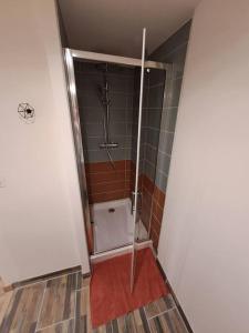 a bathroom with a shower with a glass door at Maisonnette à 1 km de la plage in Berck-sur-Mer