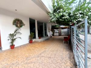 a hallway of a house with plants and a fence at The Sky Imperial Hotel Yahvi in Vadodara