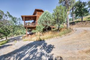 a house on the side of a hill with trees at Perk Canyon Hidden Acres-Hot Tub-Gas Fireplace in Ruidoso