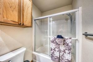 a shower with a glass door in a bathroom at Perk Canyon Hidden Acres-Hot Tub-Gas Fireplace in Ruidoso +47 photos