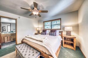 a bedroom with a bed and a ceiling fan at Perk Canyon Hidden Acres-Hot Tub-Gas Fireplace in Ruidoso