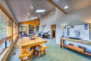 a living room with a wooden table and a couch at Perk Canyon Hidden Acres-Hot Tub-Gas Fireplace in Ruidoso
