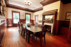 a dining room with a table and chairs and a fireplace at Belton Bed and Breakfast in Belton