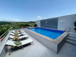 a swimming pool on the roof of a house at Hotel Legiandro Surami in Surami