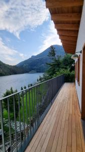 a wooden balcony with a view of a lake at B&B Villa Grazia in Darfo