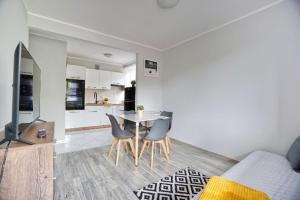 a living room with a table and chairs and a kitchen at APARTAMENT SOLINA in Solina