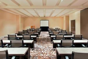 an empty classroom with tables and chairs and a screen at The Westin Wilmington in Wilmington