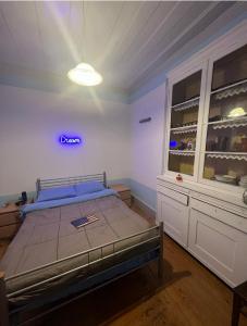 a bedroom with a bed with a blue sign on the wall at Casa Flamingo in Figueira da Foz