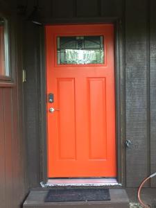 an orange door with a window on a house at Alaskan Adventure Awaits! in Eagle River