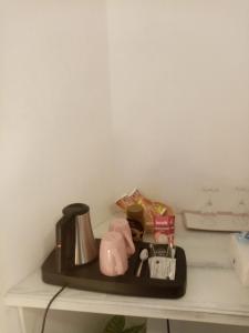 a shelf with a coffee maker and other items on it at Rooms Serafin-Lavanda in Motovun