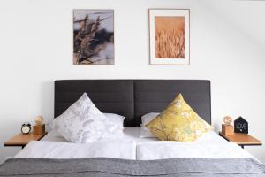 a bedroom with a bed with two pillows at Hotel Baroko in Prague