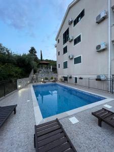 a swimming pool in front of a building at The Wave in Tivat