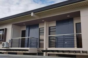 a house with a balcony in front of it at Stylish Townhouse in Balanga City Quiet Neighborhood in Balanga