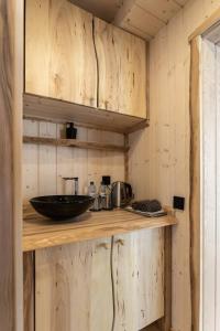 a kitchen with a wooden counter with a bowl on it at Pirtsmāja diviem Līčezeri in Balvi