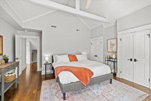 a white bedroom with a bed and a desk at German Village Serenity, Steps to Schiller Park in Columbus