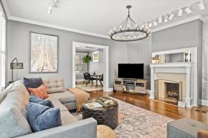 a living room with a couch and a fireplace at German Village Serenity, Steps to Schiller Park in Columbus
