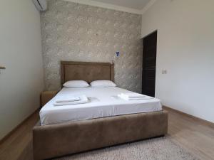 a bedroom with a bed with two towels on it at Siran Guest House in Areni