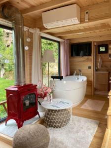 a bathroom with a tub and a red stove at Vagona Tiny House in Rize
