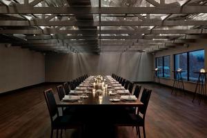 a large conference room with a long table with chairs at The Wick, Hudson, a Tribute Portfolio Hotel in Hudson