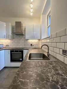 a kitchen with a sink and a counter top at Marble Arch Apartment, 2-Bedroom in London