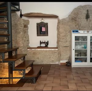 una cocina con una gran pared de piedra en Casa Vacanze "Un sogno nel Blu'" en Baunei