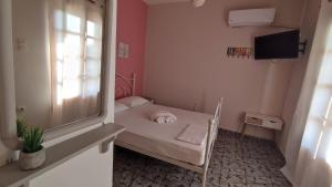 a small room with a small bed and a window at Tramonto Nel Delfini in Kini