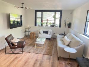 a living room with a couch and chairs at SunStar Alaska Bed and Breakfast LLC in Anchorage