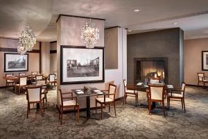 a dining room with tables and chairs and chandeliers at The Westin Edmonton in Edmonton