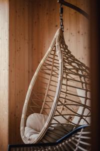 a rattan hammock hanging from a wall at Stadl Chalet oberhalb Brixen in Rosa