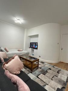 a living room with a couch and a coffee table at Marble Arch Apartment, 2-Bedroom in London