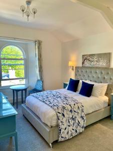 a bedroom with a large bed and a window at Gresham Court in Torquay