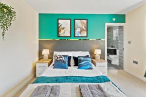 - une chambre dotée d'un mur vert et d'un lit avec des oreillers bleus dans l'établissement Central Leeds Gem - Parking - Sleeps 6, à Leeds